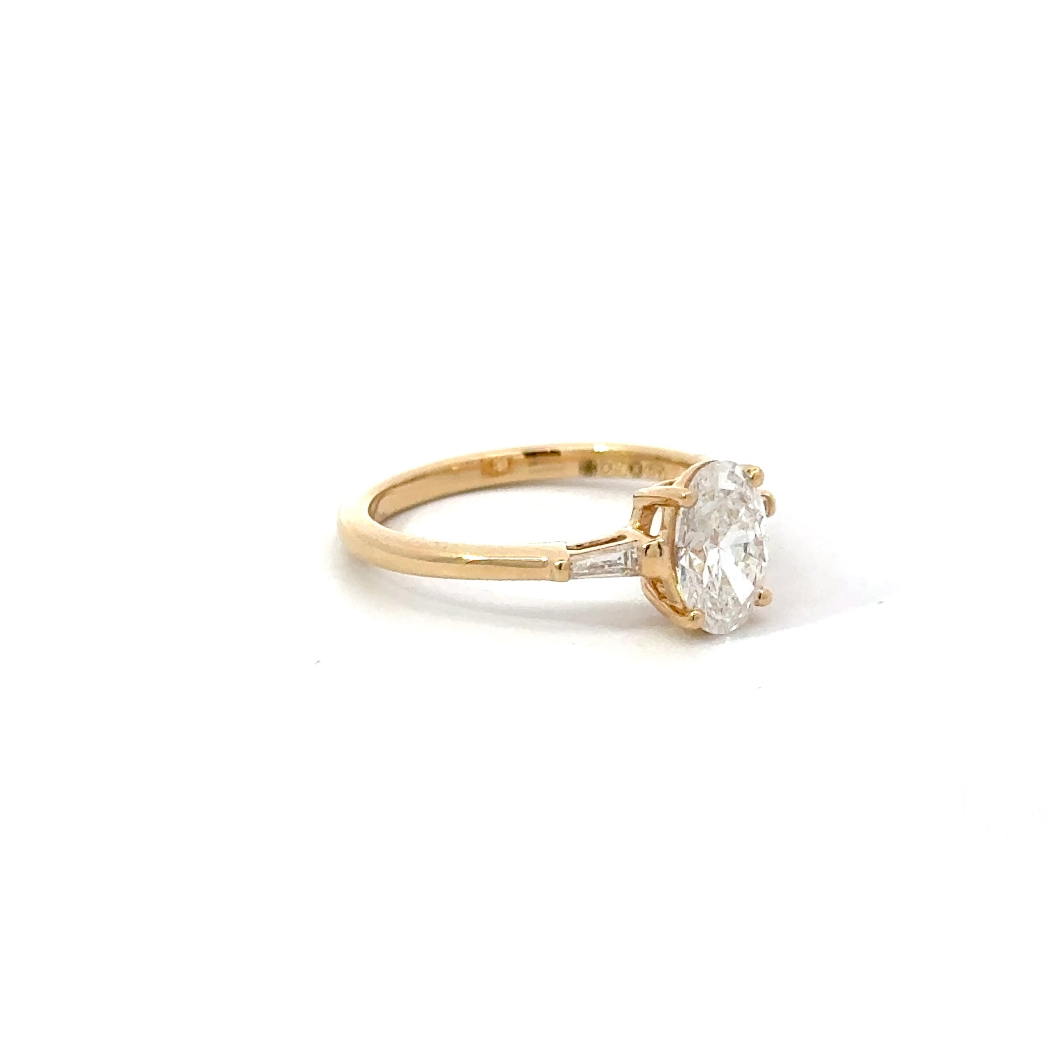 1.11ct Oval Brilliant Cut Lab Grown Diamond 3 Stone With Tapered Baguette Side Stones Set in 18ct Yellow Gold