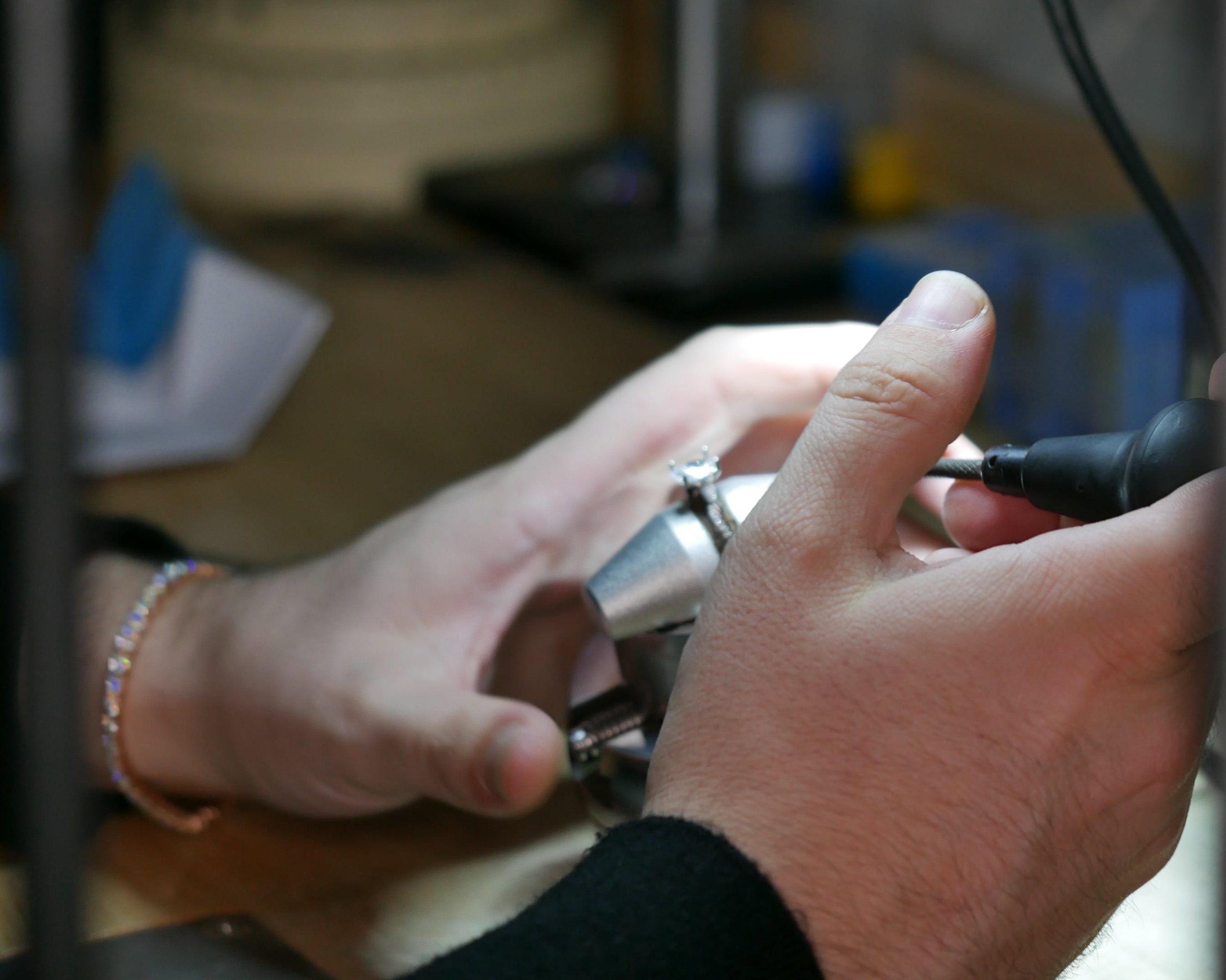 Close-up of hands working on electronic equipment with a blurred background