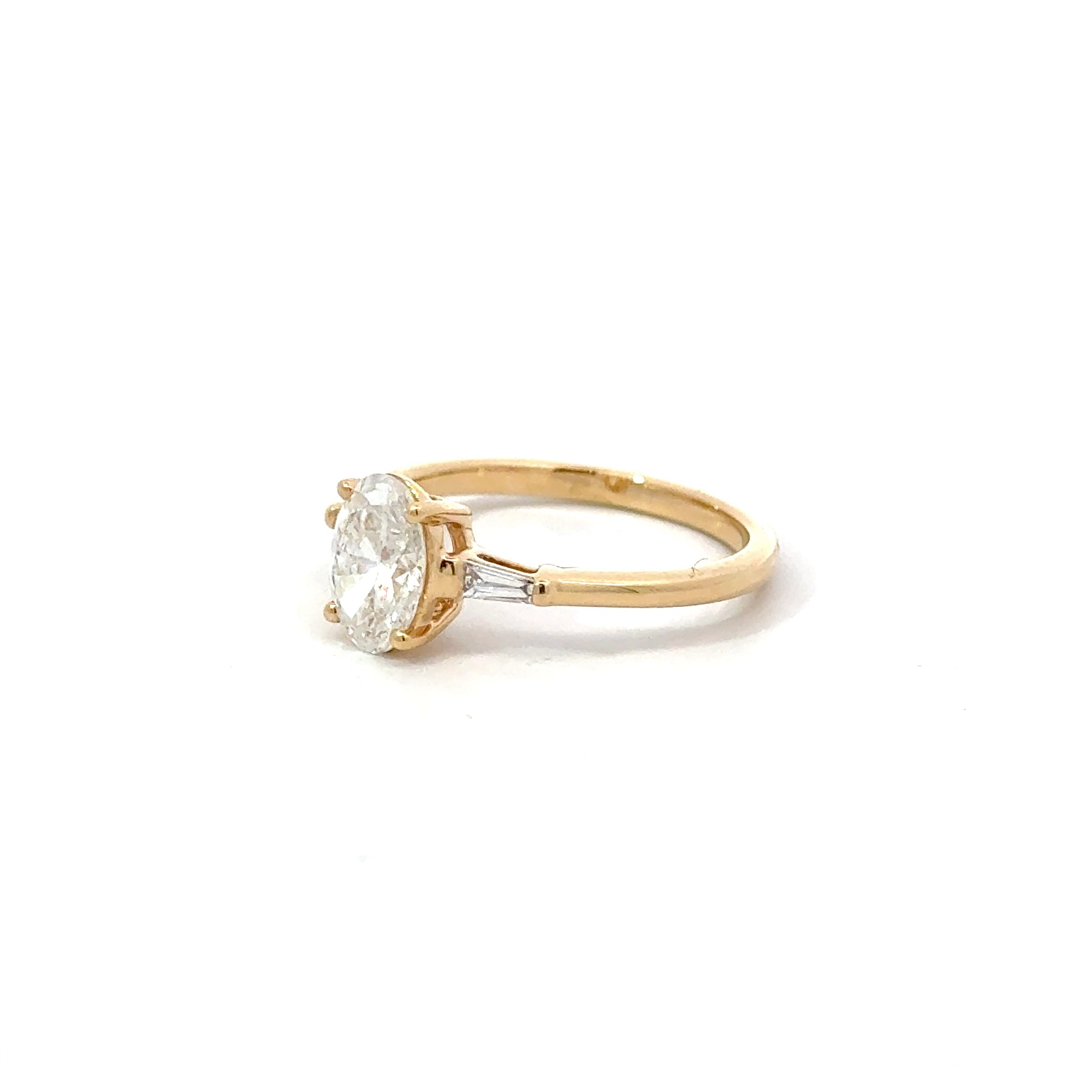 1.11ct Oval Brilliant Cut Lab Grown Diamond 3 Stone With Tapered Baguette Side Stones Set in 18ct Yellow Gold