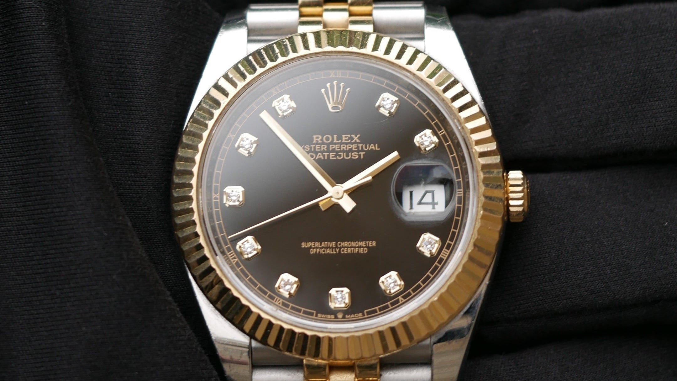 Luxury watch with silver and gold band on a black background